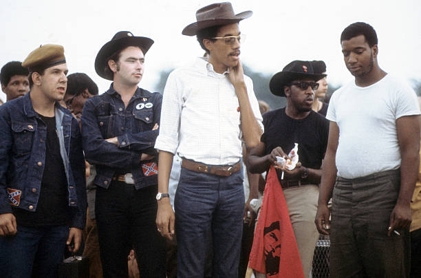 Left to right, Young Patriots Organization (YPO) leader Bill 'Preacherman' Fesperman (second from left in cowboy hat), Black Panther Party leaders Bobby Lee, Billy 'Che' Brooks (in dark shirt), and Fred Hampton, with arms at his side, attend a downtown rally near the band shell of Grant Park,, Chicago, Illinois, 1969. (Photo by Paul Sequeira/Getty Images)